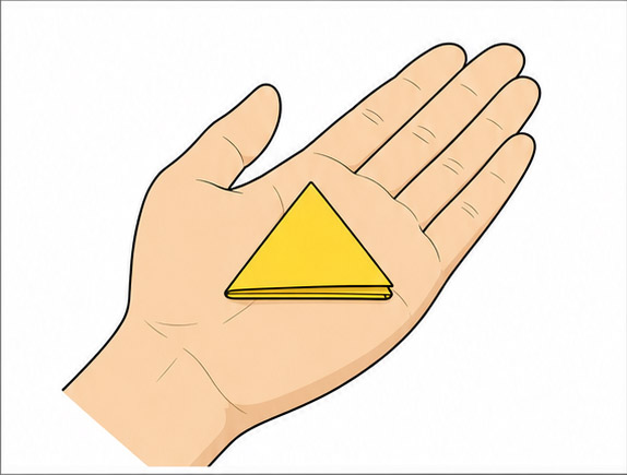 A folded yellow talisman resting respectfully in an open hand